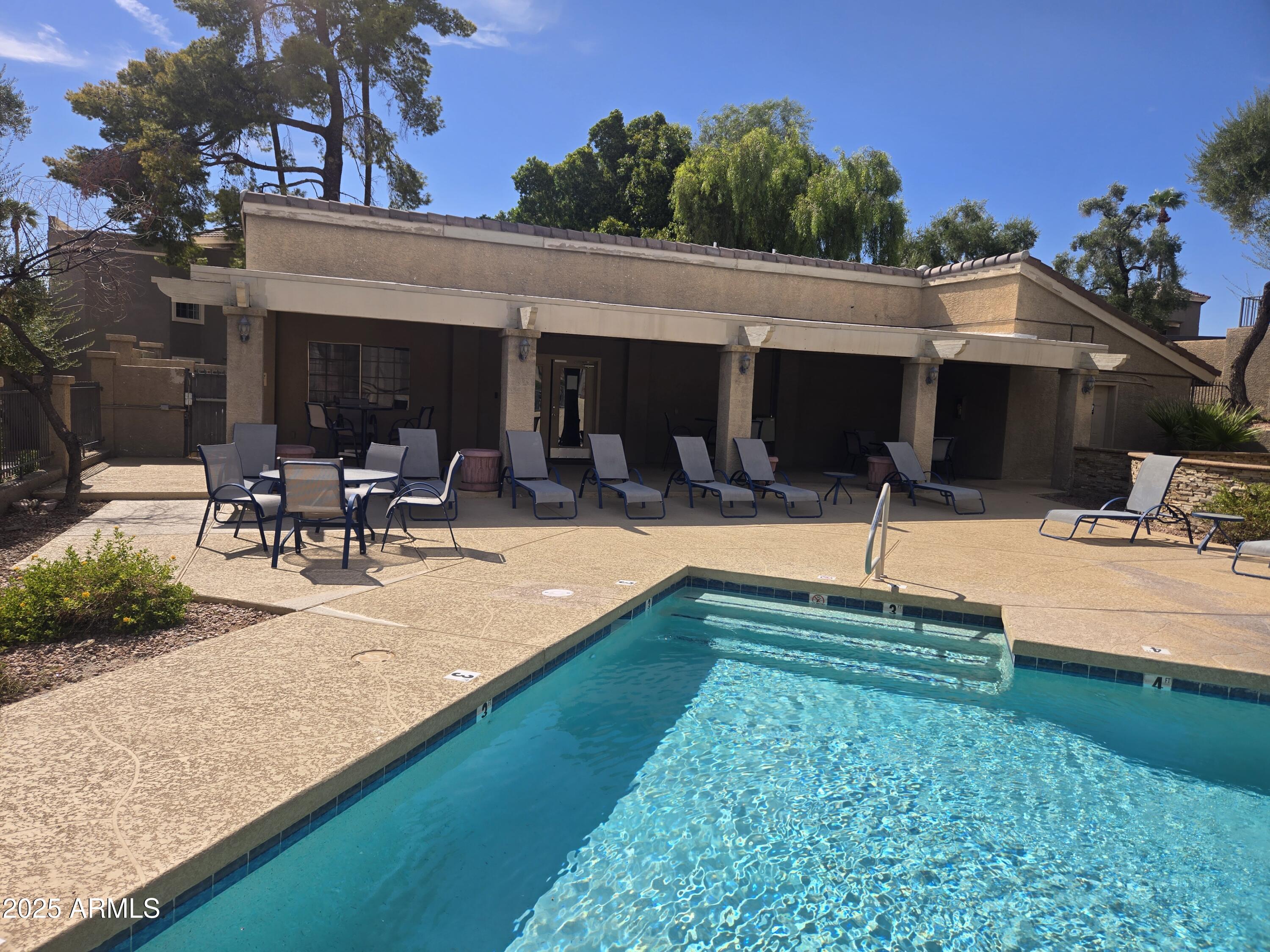 1720 East Thunderbird Road, Unit 2094 Phoenix, AZ 85022 - Photo 33 of 36 a swimming pool with outdoor seating and yard