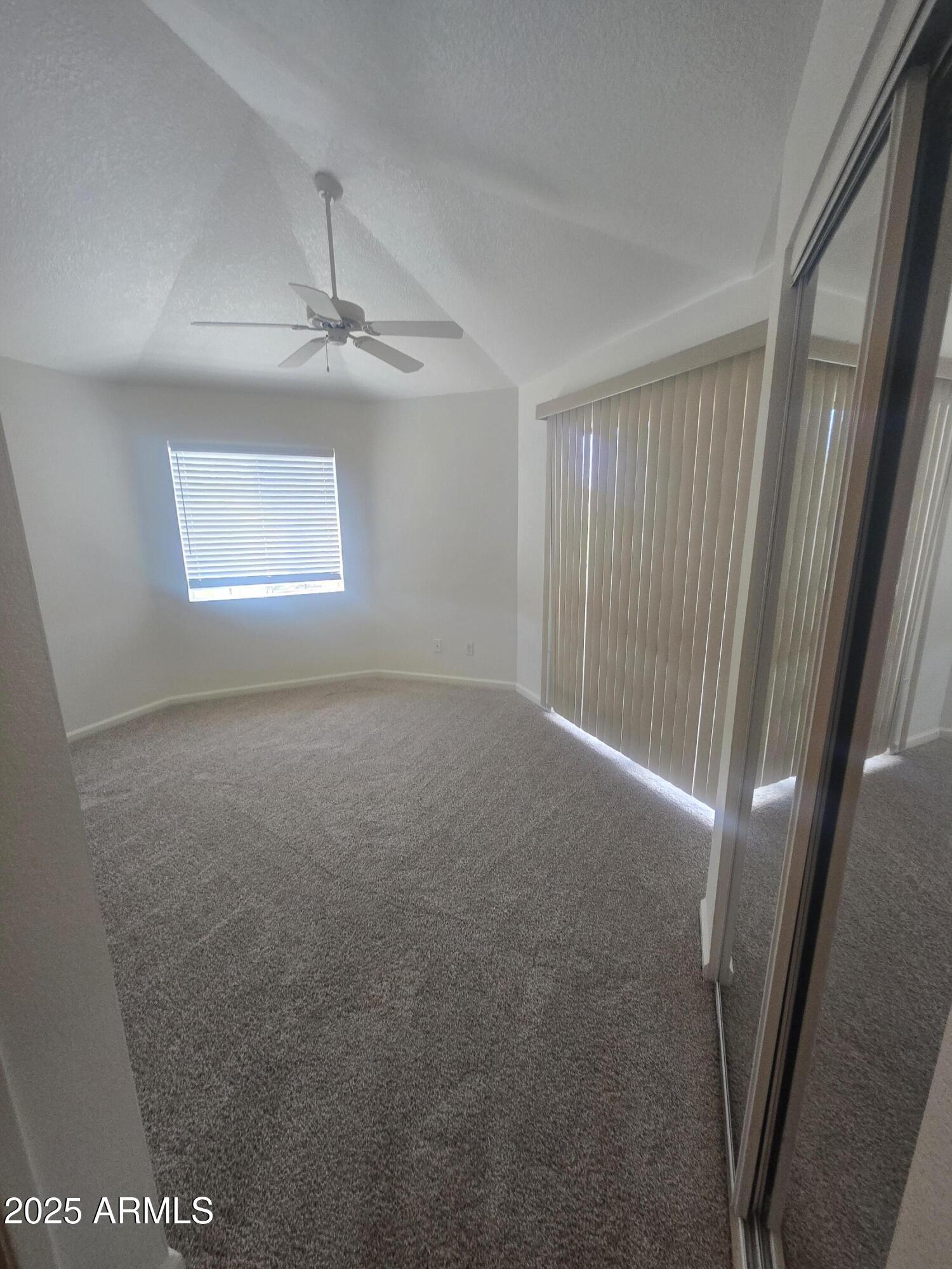1720 East Thunderbird Road, Unit 2094 Phoenix, AZ 85022 - Photo 10 of 36 an empty room with windows and fan