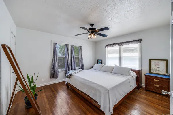 a bedroom with a large bed and a chandelier