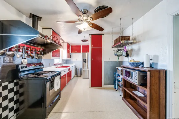 a kitchen with stainless steel appliances granite countertop a stove and a refrigerator