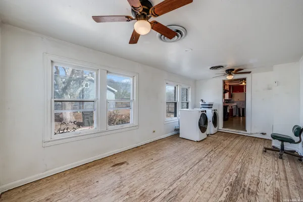 a workspace with wooden floor and windows