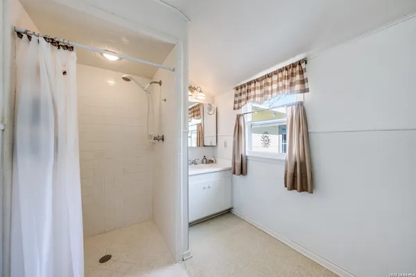 a bathroom with a shower and a tub