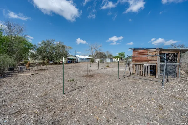 a view of a house with a backyard of a house