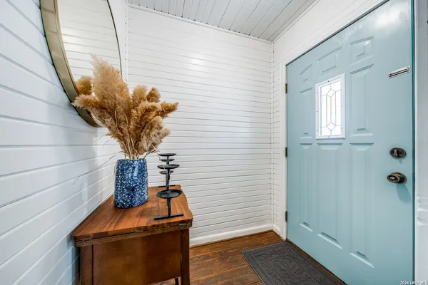 a vase of flowers sitting on a wooden floor