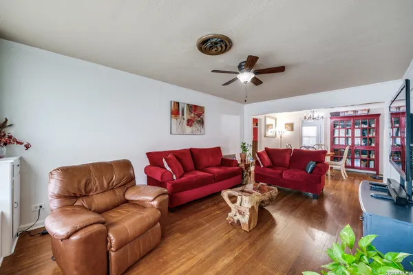 a living room with furniture a couch and a chandelier