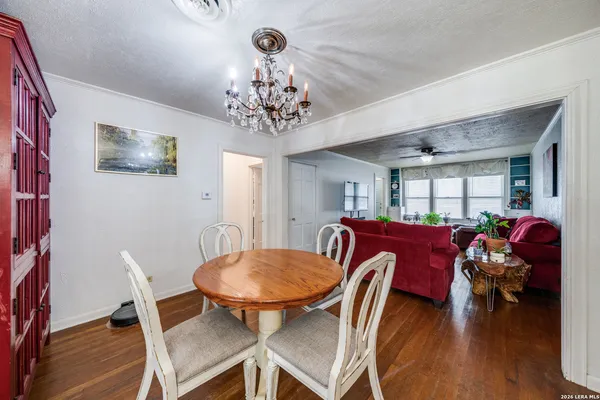 a view of a dining room with furniture wooden floor and chandelier
