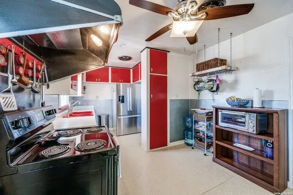 a room with lots of appliances and cabinets