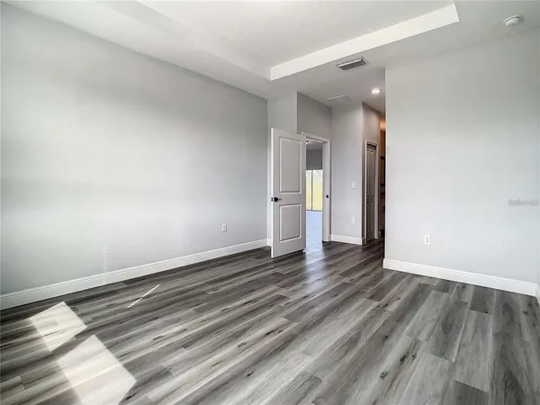 a view of an empty room and wooden floor