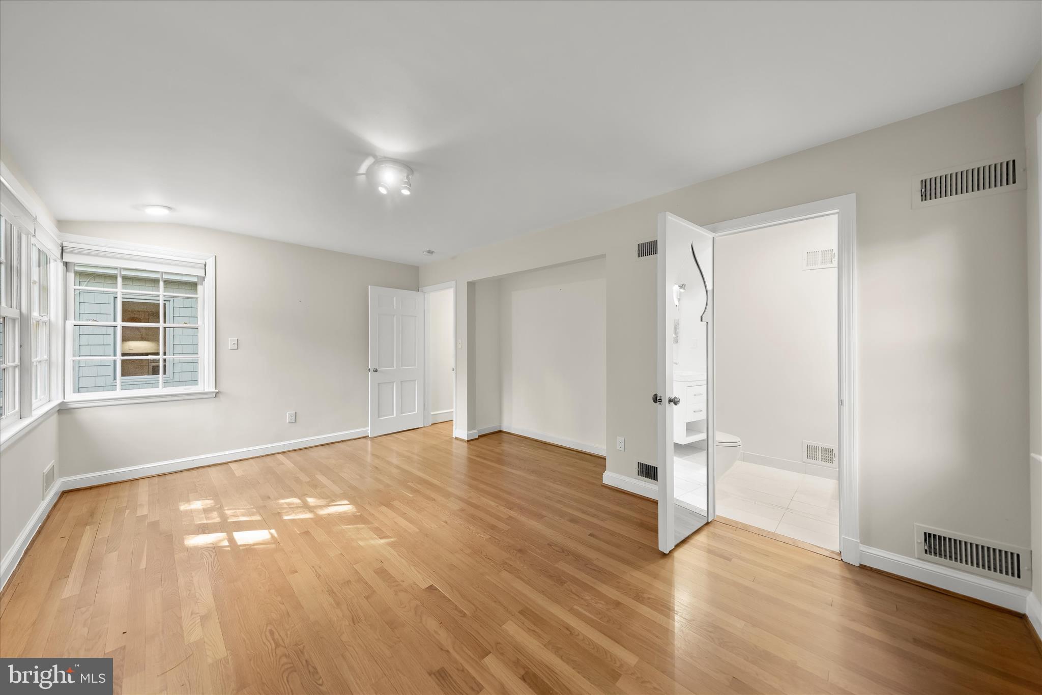 5104 Scarsdale Road Bethesda, MD 20816 - Photo 25 of 68 a view of an empty room with wooden floor and a window