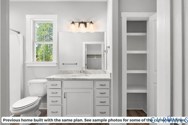 a bathroom with a sink mirror and vanity