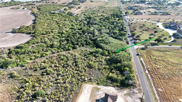 an aerial view of a houses with a yard
