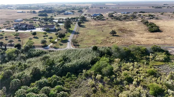 an aerial view of a house with a yard and outdoor seating