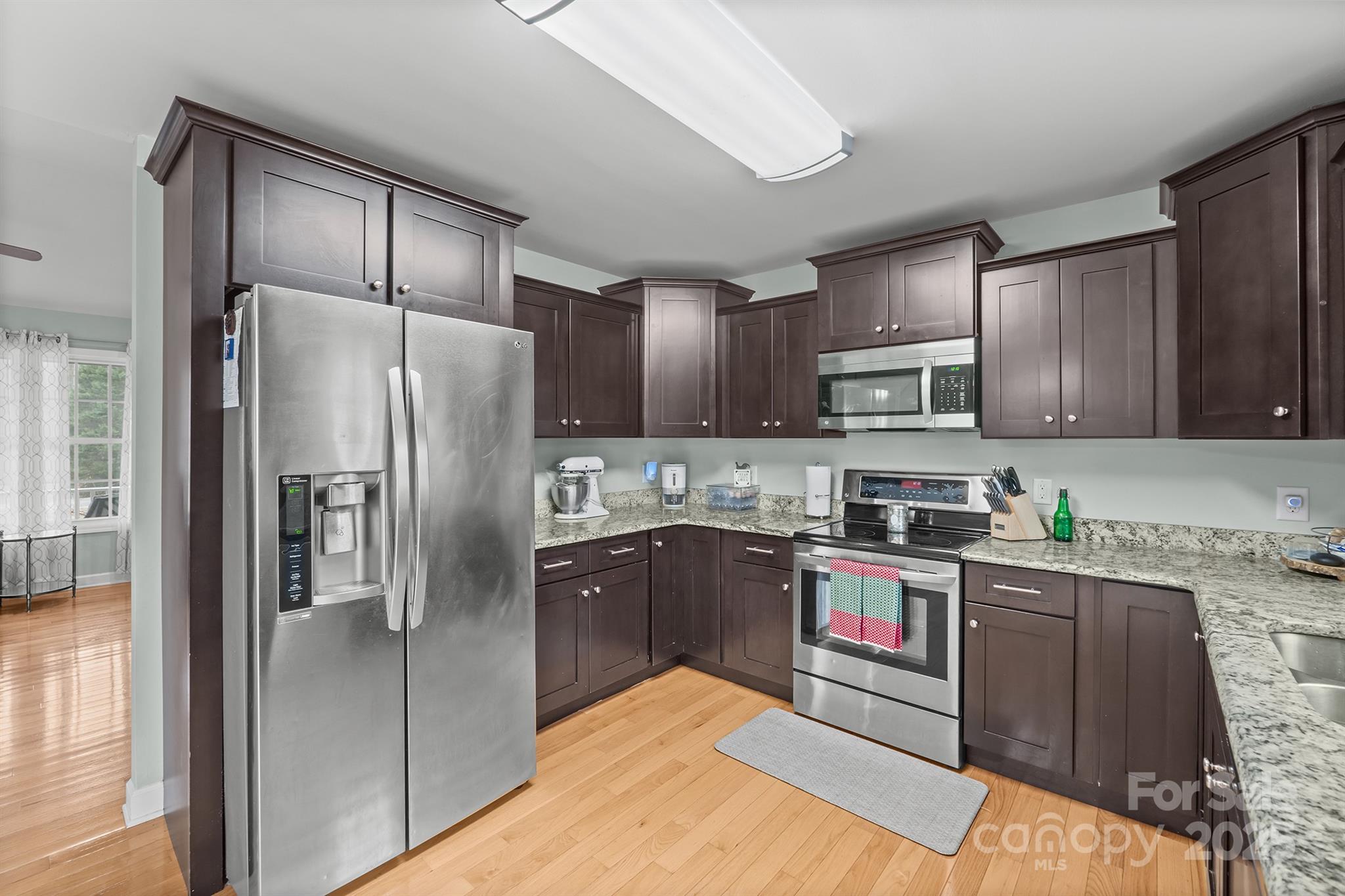 2572 Rock Dam Road Lincolnton, NC 28092 - Photo 16 of 30 a kitchen with granite countertop stainless steel appliances cabinets a sink and a counter top space