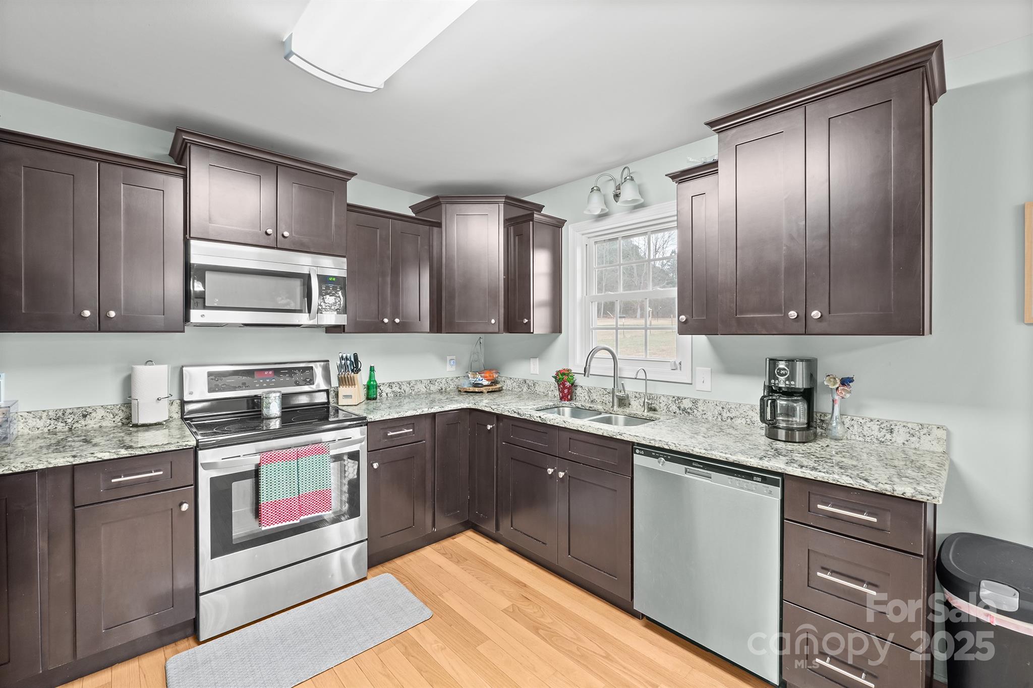 2572 Rock Dam Road Lincolnton, NC 28092 - Photo 17 of 30 a kitchen with kitchen island granite countertop stainless steel appliances stove sink and cabinets