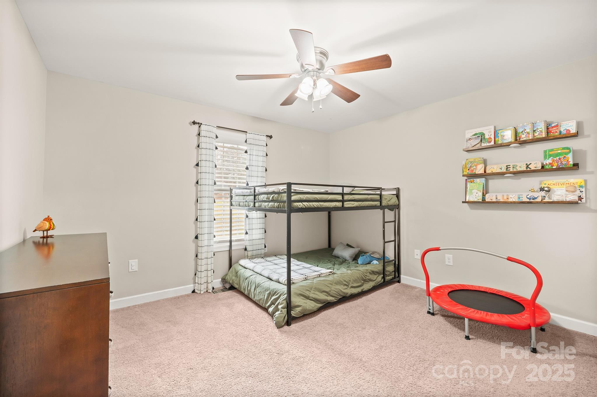 2572 Rock Dam Road Lincolnton, NC 28092 - Photo 23 of 30 a bedroom with a bed and a chandelier