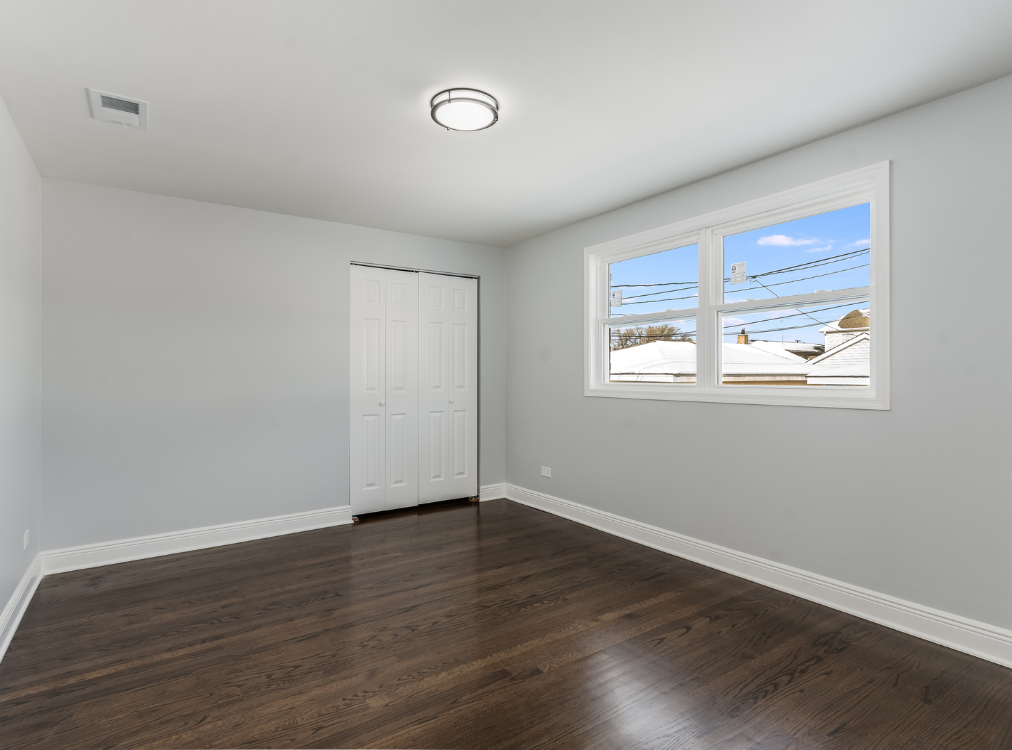 7502 64th Street Summit, IL 60501 - Photo 12 of 31 a view of an empty room with wooden floor and a window