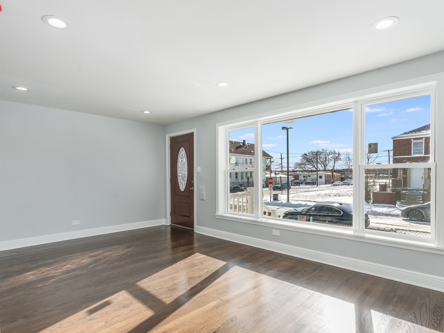 7502 64th Street Summit, IL 60501 - Photo 7 of 31 a view of an empty room with wooden floor and a window