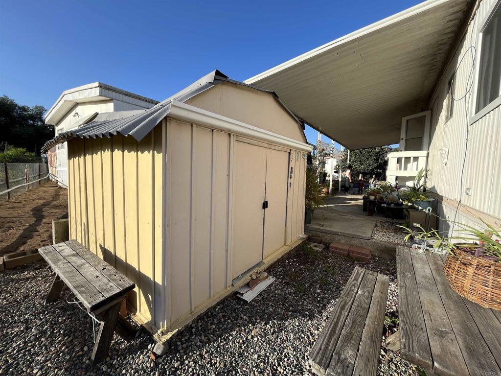 1810 Hillsdale Road, Unit 99 El Cajon, CA 92019 - Photo 14 of 15 a yellow house with table and chairs