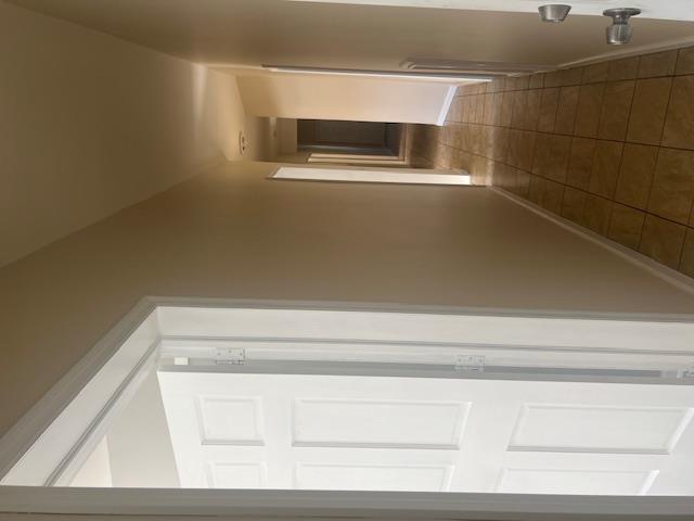 88-40 88th Street Queens, NY 11421 - Photo 12 of 18 Hallway featuring dark tile patterned floors