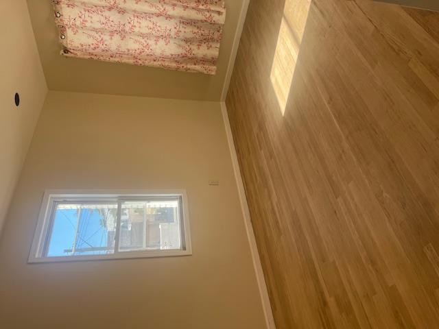 88-40 88th Street Queens, NY 11421 - Photo 13 of 18 Unfurnished room with wood-type flooring