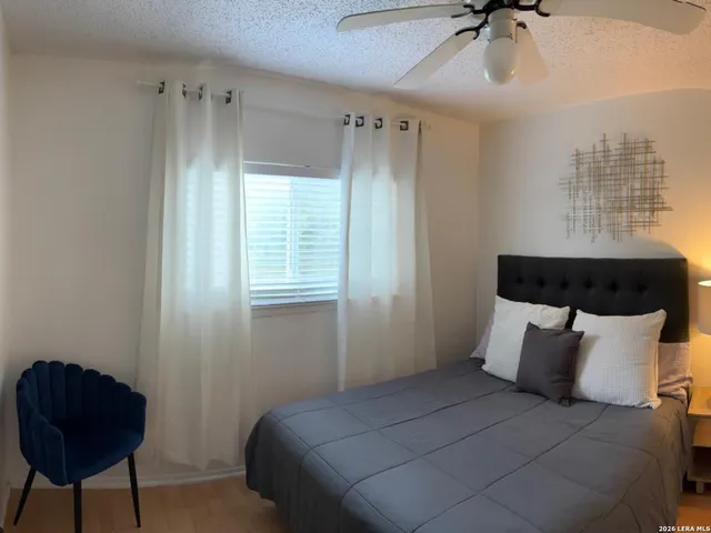 a bed room with a bed and a chair