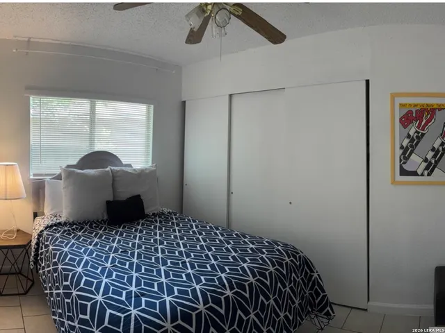 a bedroom with a bed and a window