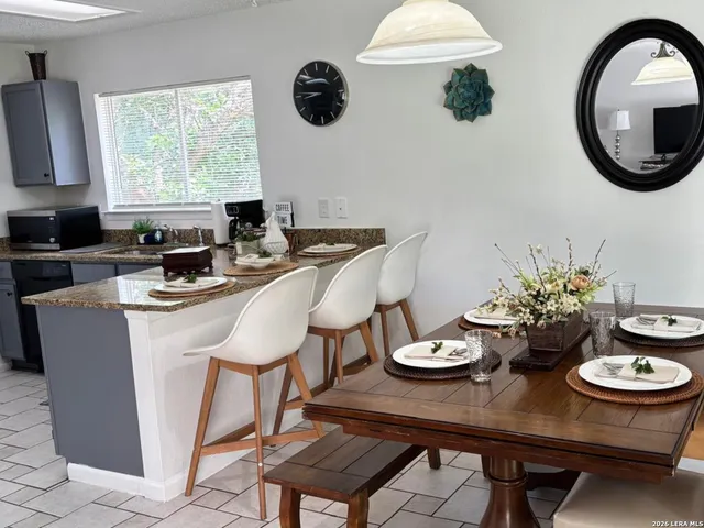 a kitchen with a table chairs stove and microwave