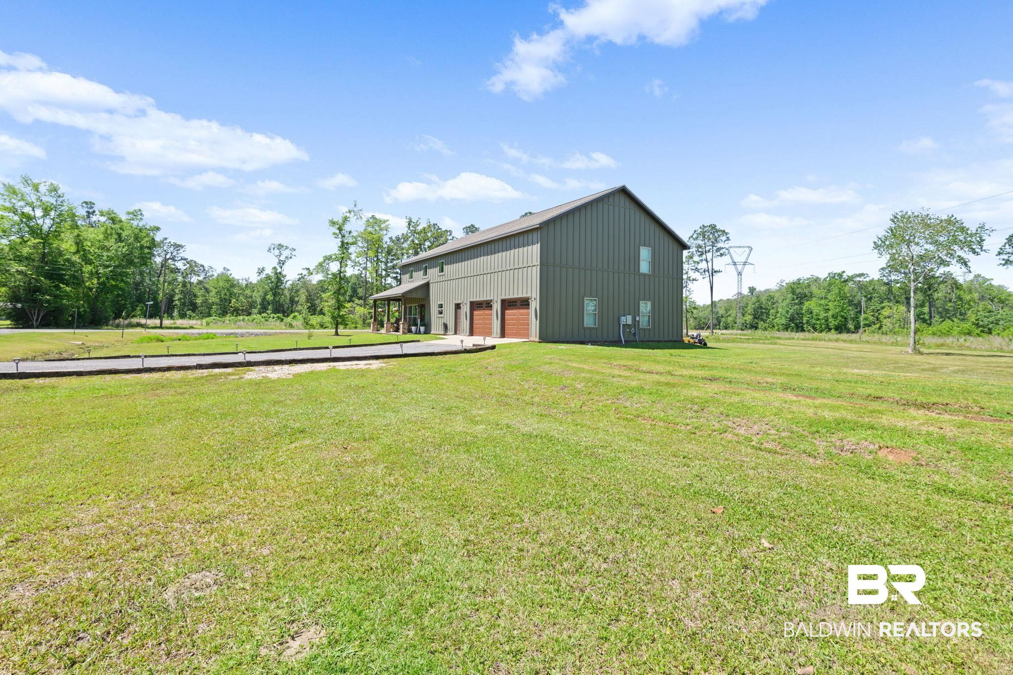 11025 Creax Road Axis, AL 36505 - Photo 9 of 45 Two-story structure featuring vertical panel siding and a gabled roofline