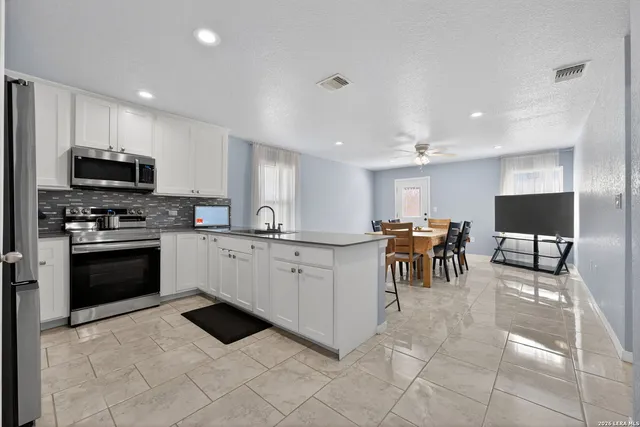 a kitchen with appliances cabinets and a sink