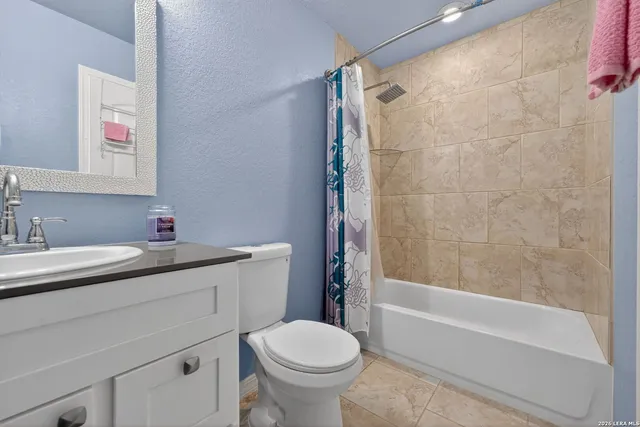 a bathroom with a sink toilet vanity and shower