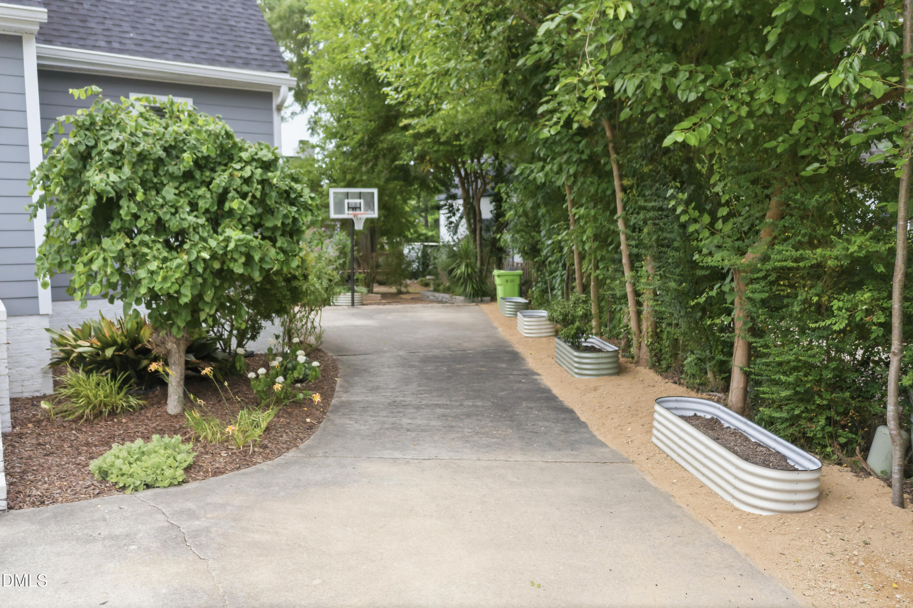 3004 West Annaley Drive Raleigh, NC 27604 - Photo 6 of 44 a view of a backyard with plants and a small yard