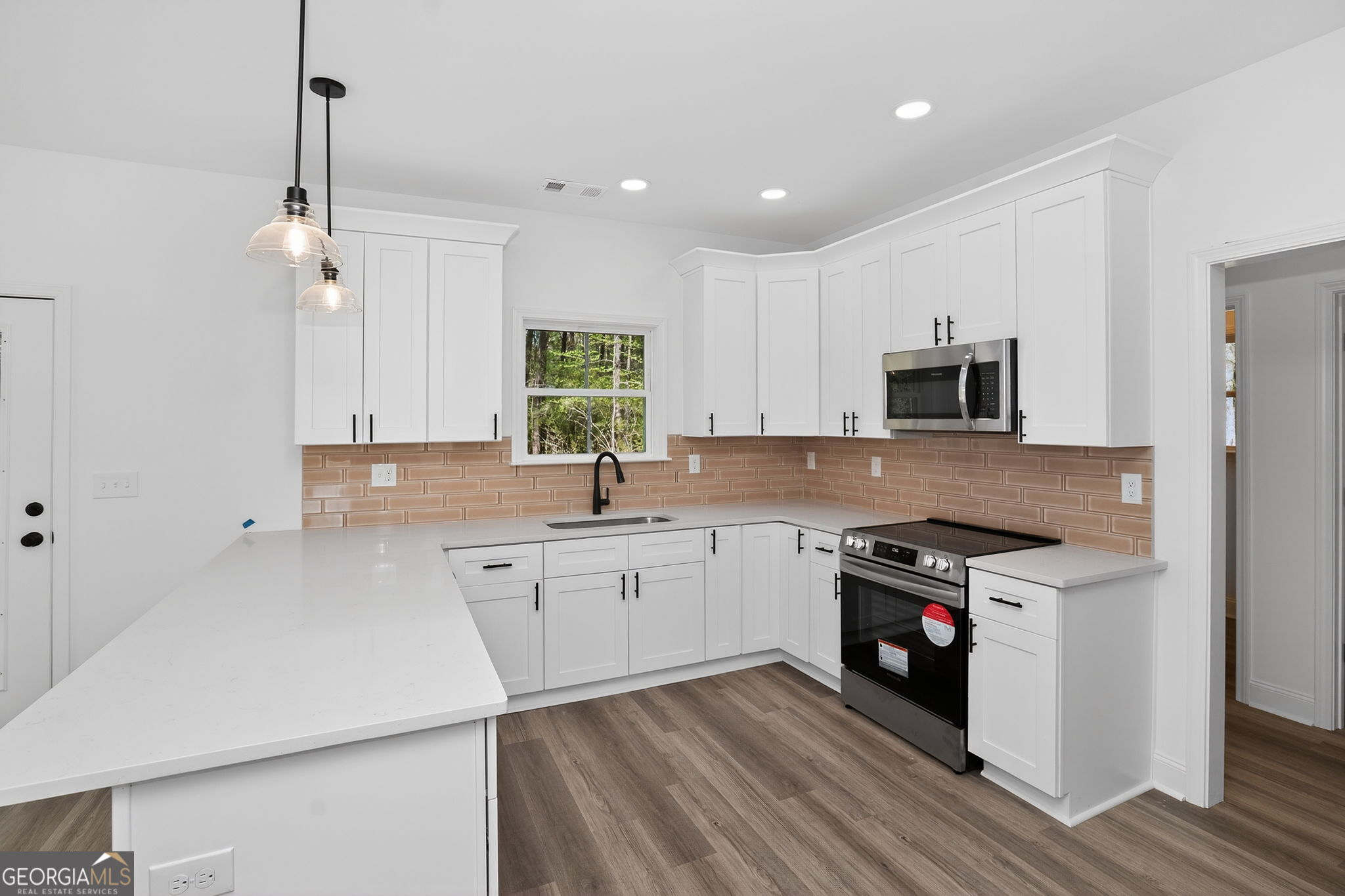 1229 Chappell Mill Road Jackson, GA 30233 - Photo 23 of 55 a kitchen with granite countertop white cabinets and white appliances
