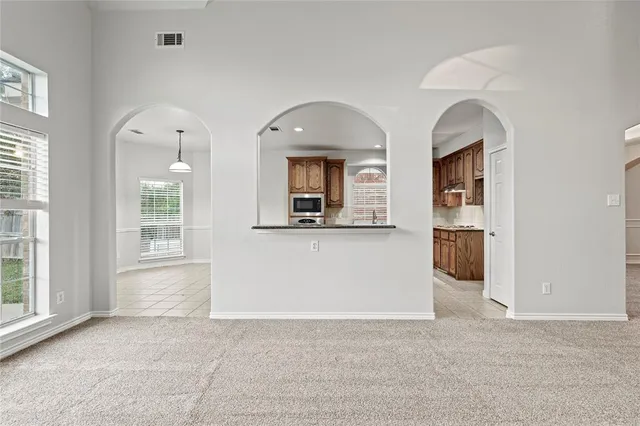 a large kitchen with stainless steel appliances kitchen island granite countertop a large counter top and a stove top oven