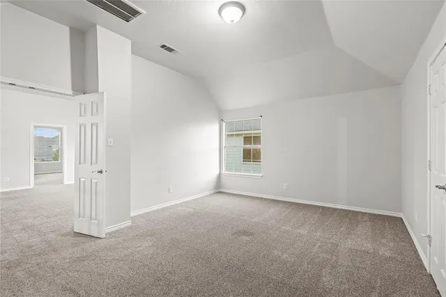 an empty room with a painting on the wall