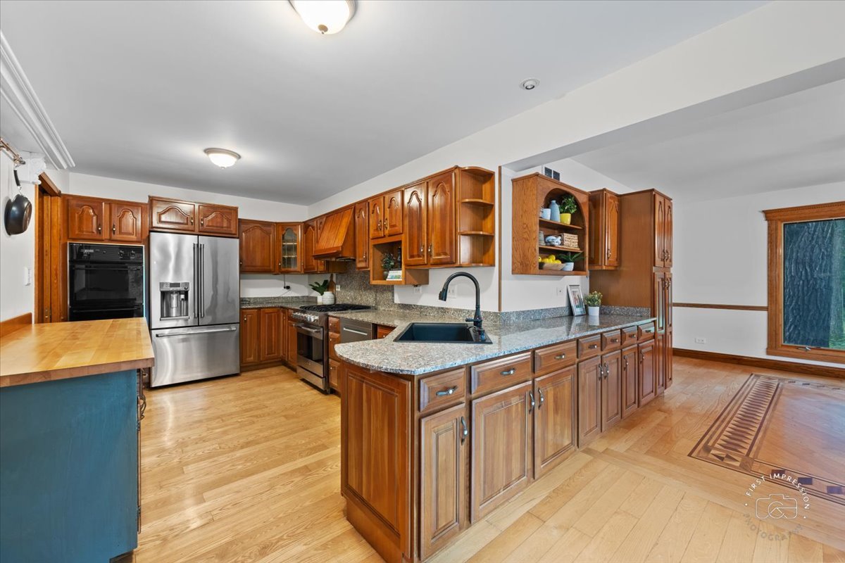 27158 West Cuba Road Barrington, IL 60010 - Photo 14 of 51 a kitchen with stainless steel appliances granite countertop a sink stove and cabinets