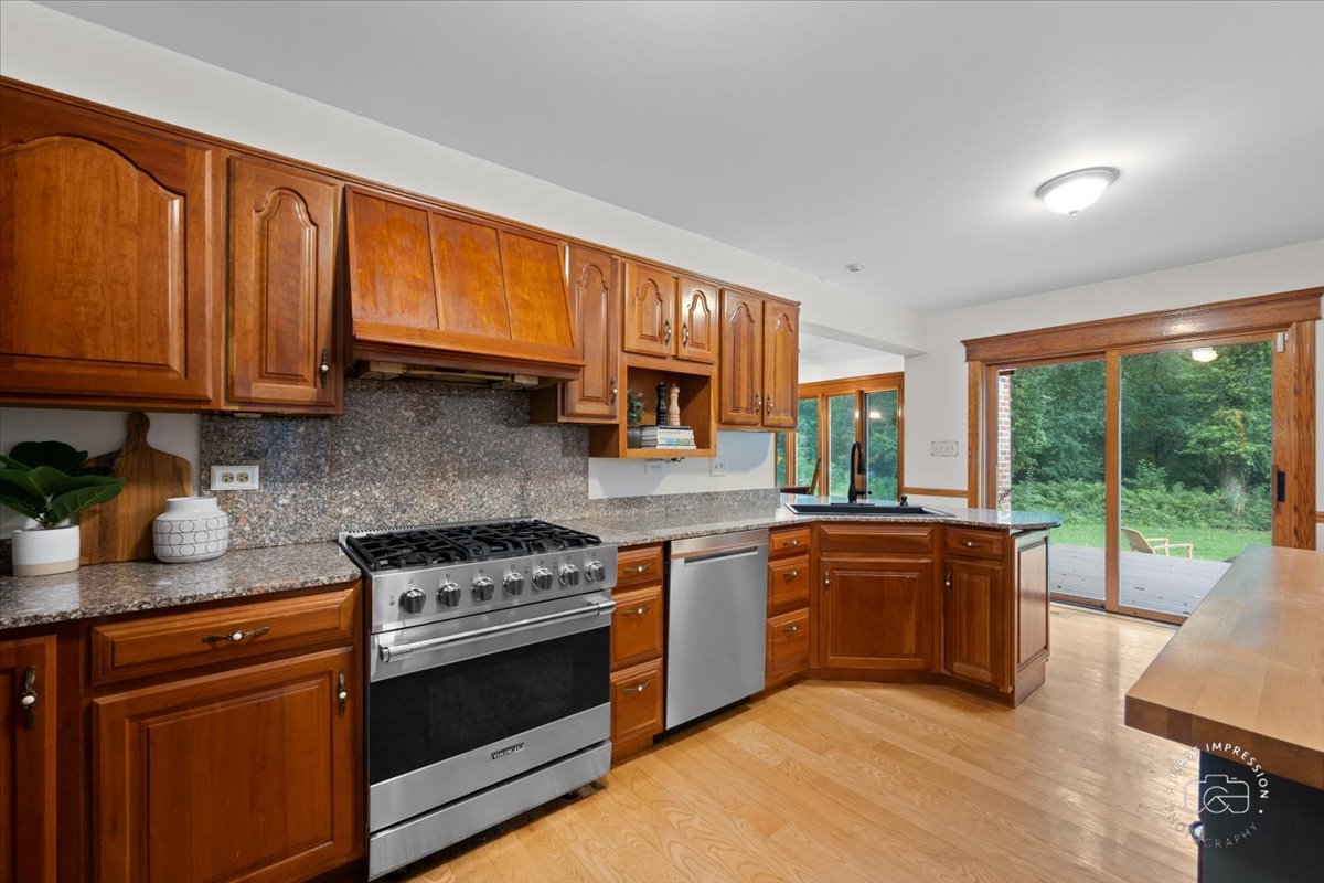 27158 West Cuba Road Barrington, IL 60010 - Photo 15 of 51 a kitchen with stainless steel appliances granite countertop a stove a sink and a microwave
