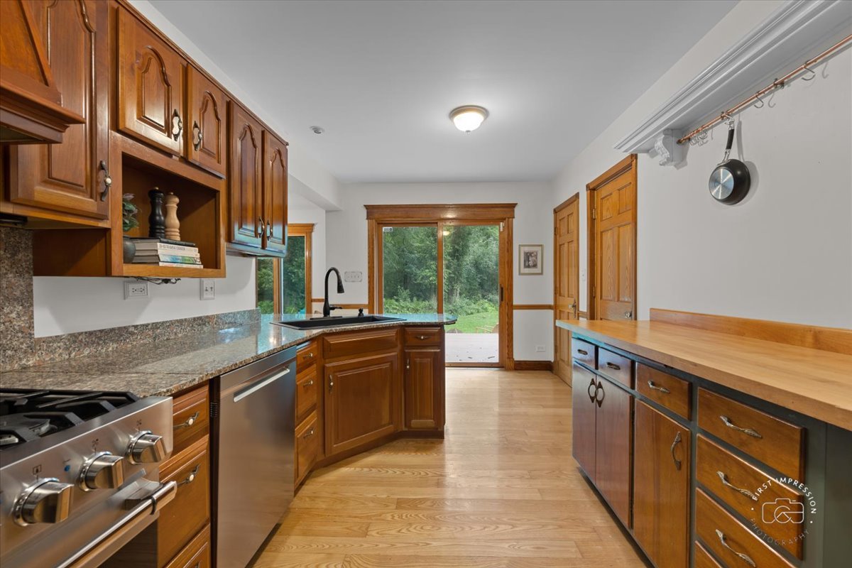 27158 West Cuba Road Barrington, IL 60010 - Photo 16 of 51 a large kitchen with stainless steel appliances granite countertop a stove a sink and a microwave