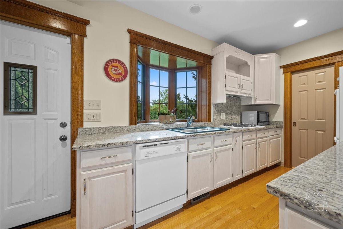 27158 West Cuba Road Barrington, IL 60010 - Photo 40 of 51 a kitchen with granite countertop white cabinets and white appliances
