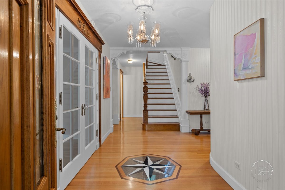 27158 West Cuba Road Barrington, IL 60010 - Photo 5 of 51 a view of a hallway with wooden floor and staircase