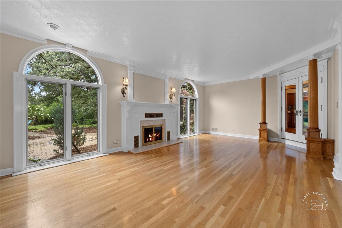 27158 West Cuba Road Barrington, IL 60010 - Photo 8 of 51 an empty room with wooden floor fireplace and windows