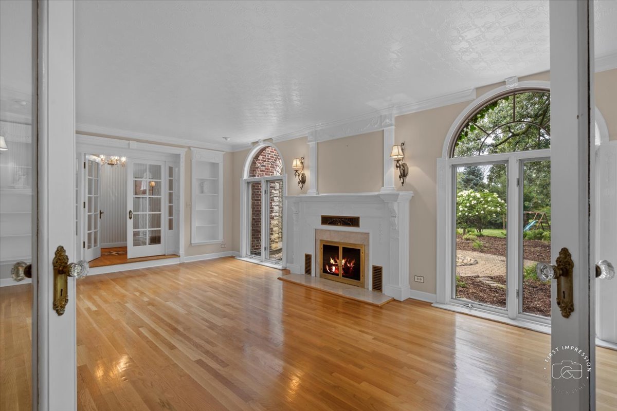 27158 West Cuba Road Barrington, IL 60010 - Photo 9 of 51 a view of an empty room with a fireplace and a window