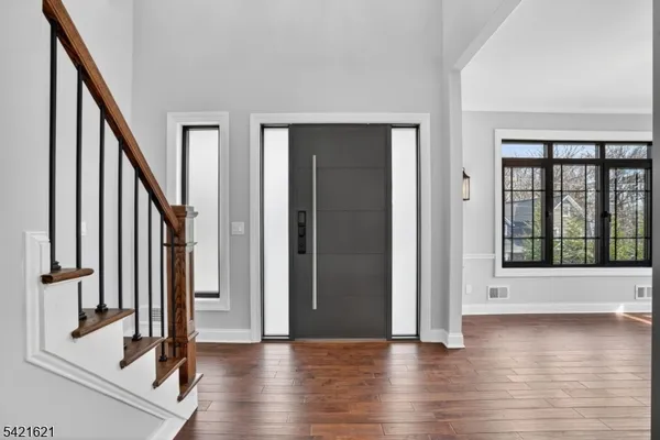 a view of an entryway with wooden floor
