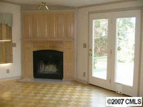 3293 Woodland Court Road Lancaster, SC 29720 - Photo 3 of 6 a view of an empty room with a fireplace and a window