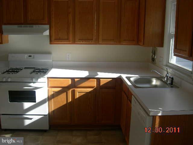 3317 Kenjac Road Windsor Mill, MD 21244 - Photo 7 of 12 a kitchen with a sink and cabinets