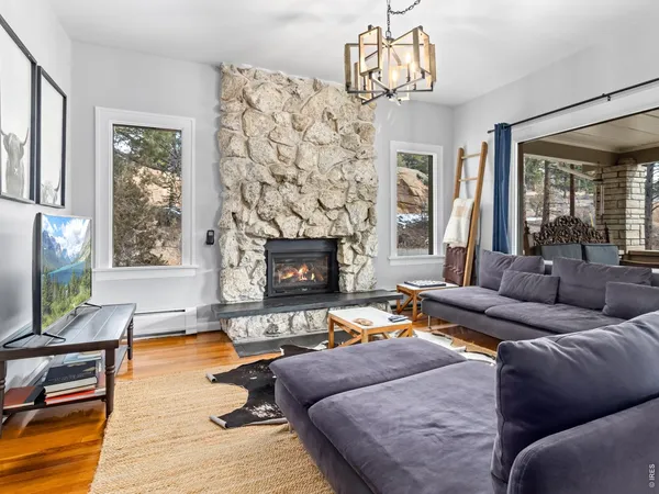 a living room with a bed furniture and a large window