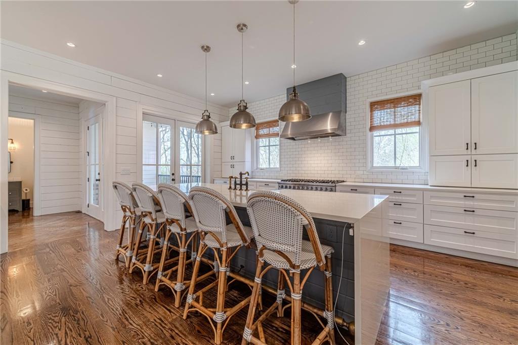 220 Audreys Way Suwanee, GA 30024 - Photo 17 of 66 a large kitchen with a table and chairs