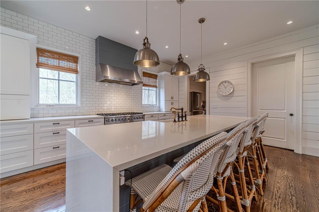 220 Audreys Way Suwanee, GA 30024 - Photo 18 of 66 a large kitchen with a table and chairs