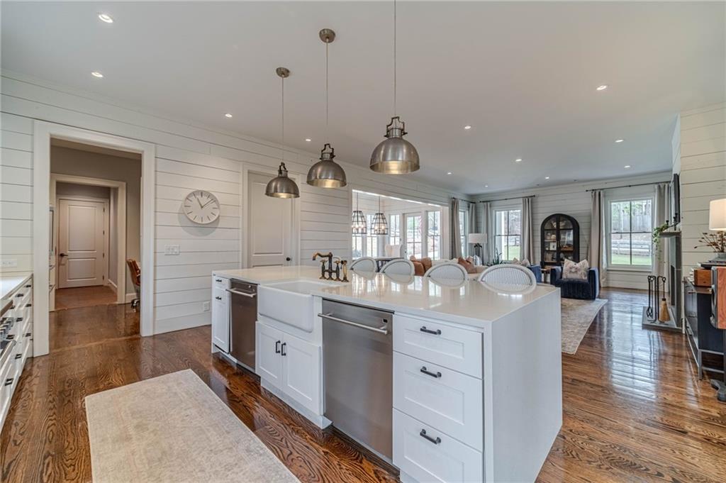 220 Audreys Way Suwanee, GA 30024 - Photo 19 of 66 a large white kitchen with a lot of counter space and wooden floor