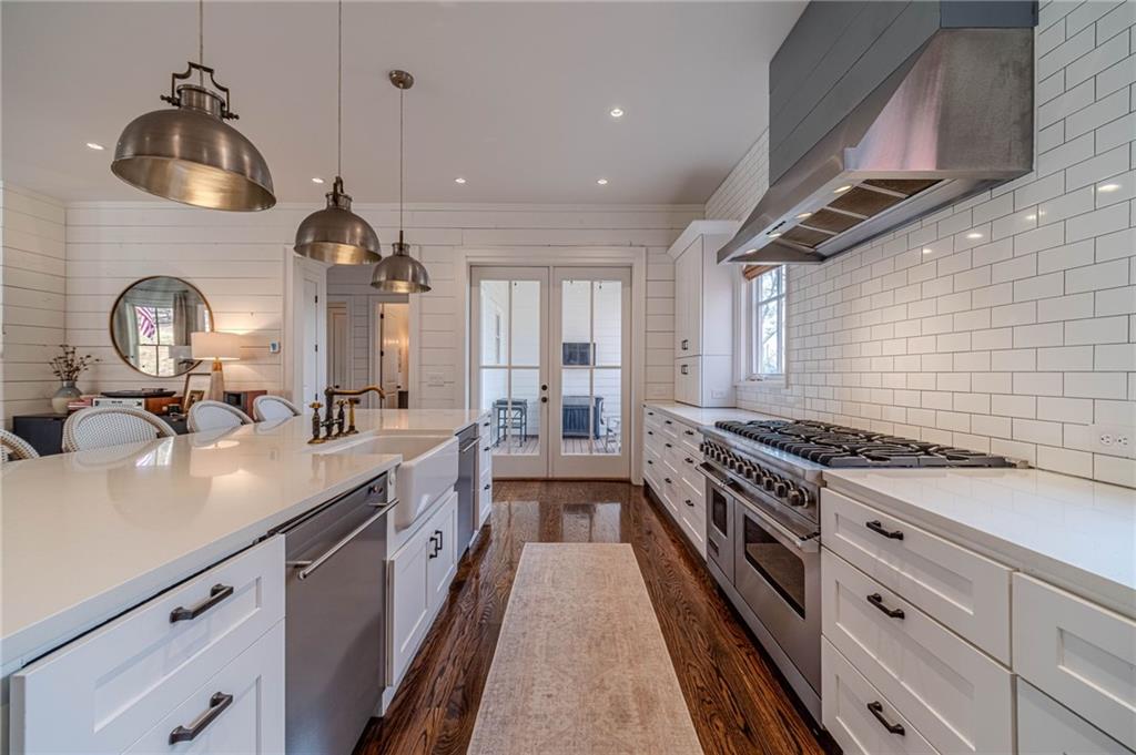 220 Audreys Way Suwanee, GA 30024 - Photo 21 of 66 a kitchen with kitchen island granite countertop a stove and a sink