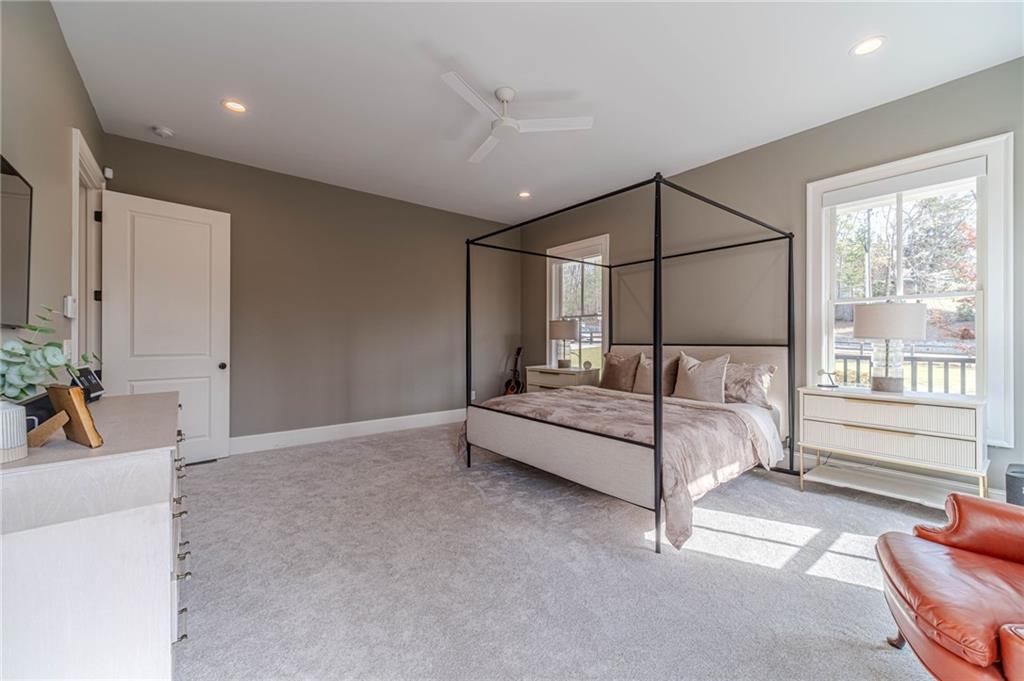 220 Audreys Way Suwanee, GA 30024 - Photo 29 of 66 a bedroom with furniture and a large window